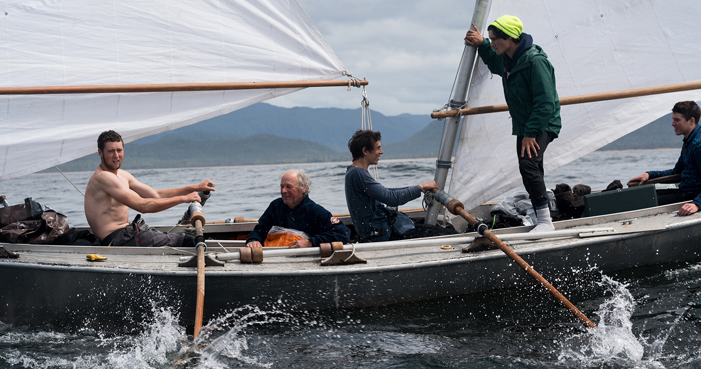 Student and his team rowing in the water during the race. 