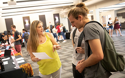 Students talk to representatives from different colleges. 