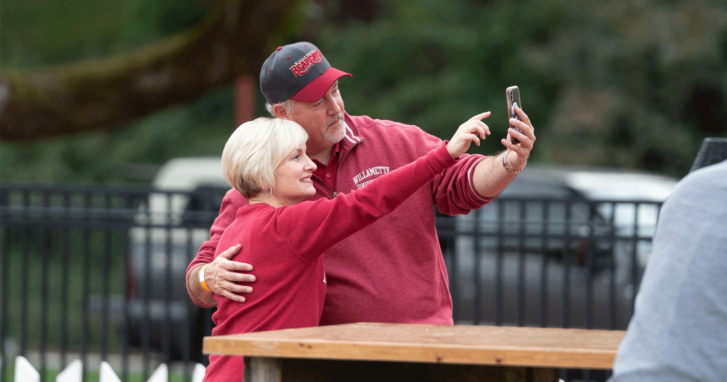 two individuals take a selfie at homecoming