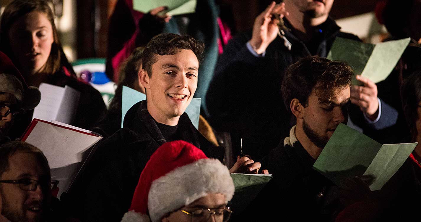 A small choir on the steps of Waller sings carols