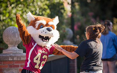 Blitz the Bearcat dances with student