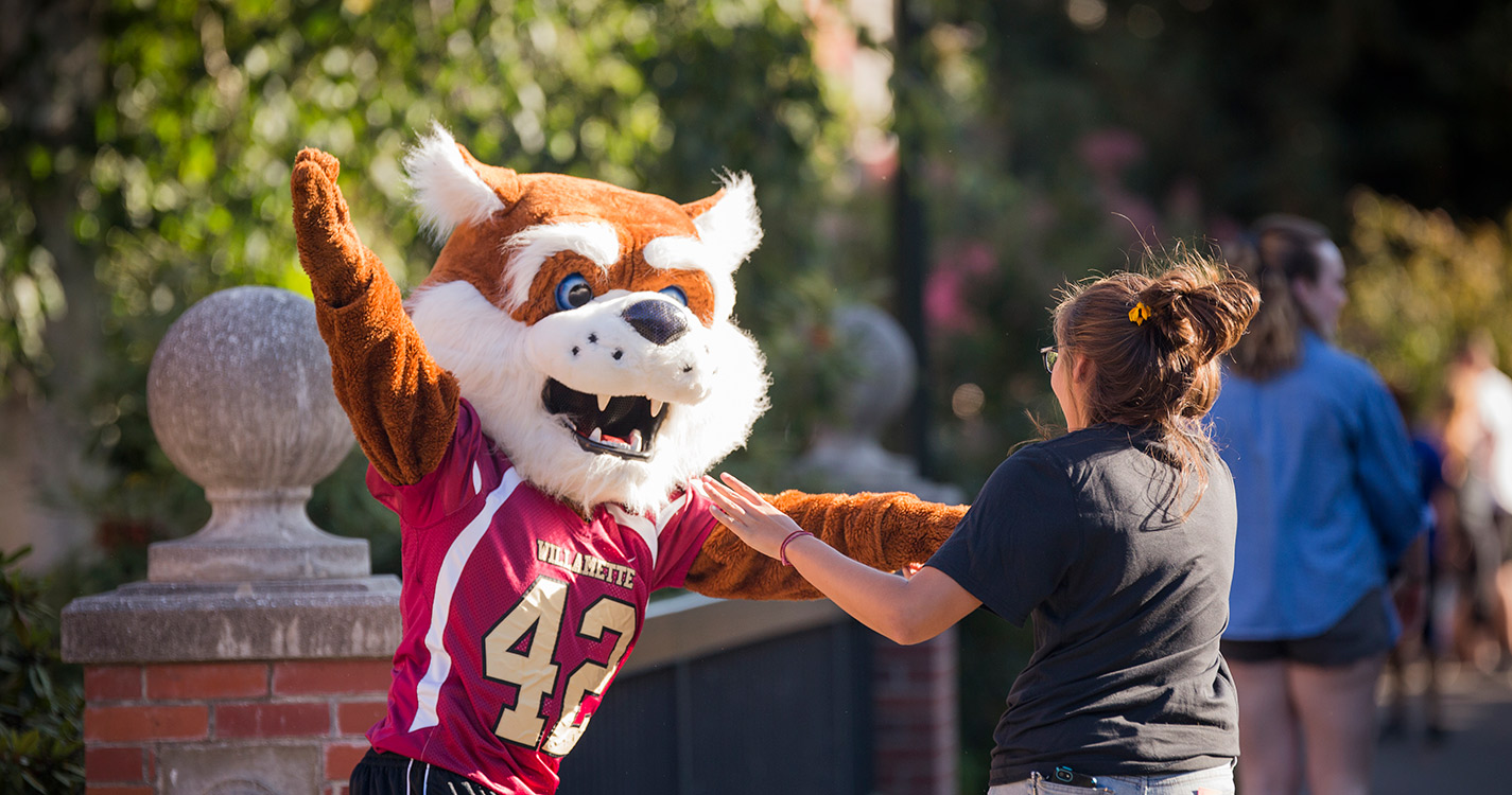 Blitz the Bearcat dances with student