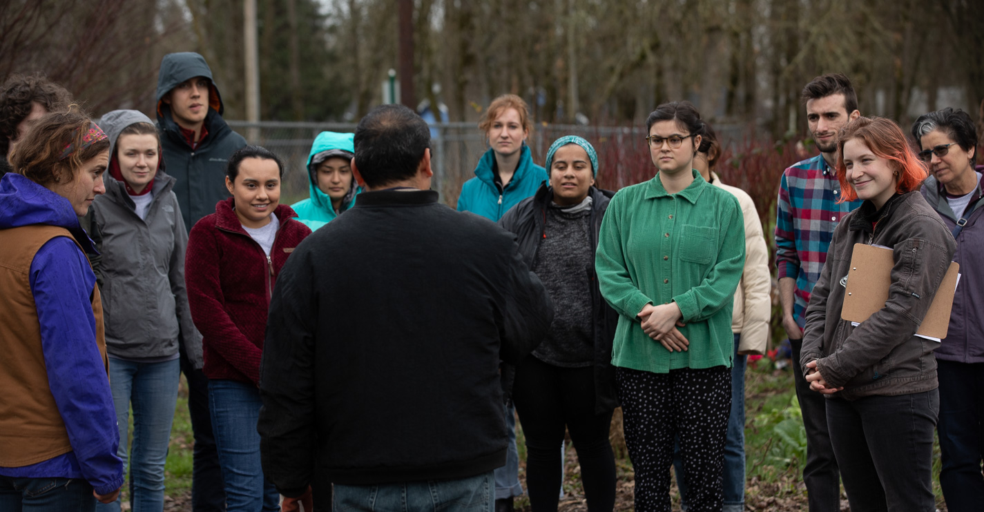 Students receive instructions for the service project at community garden