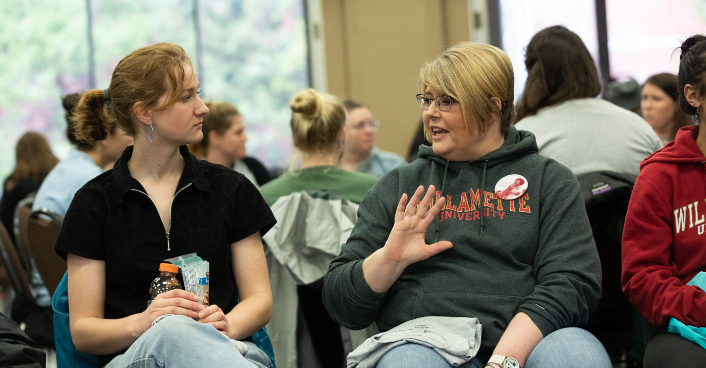 Two people seated in a discussion