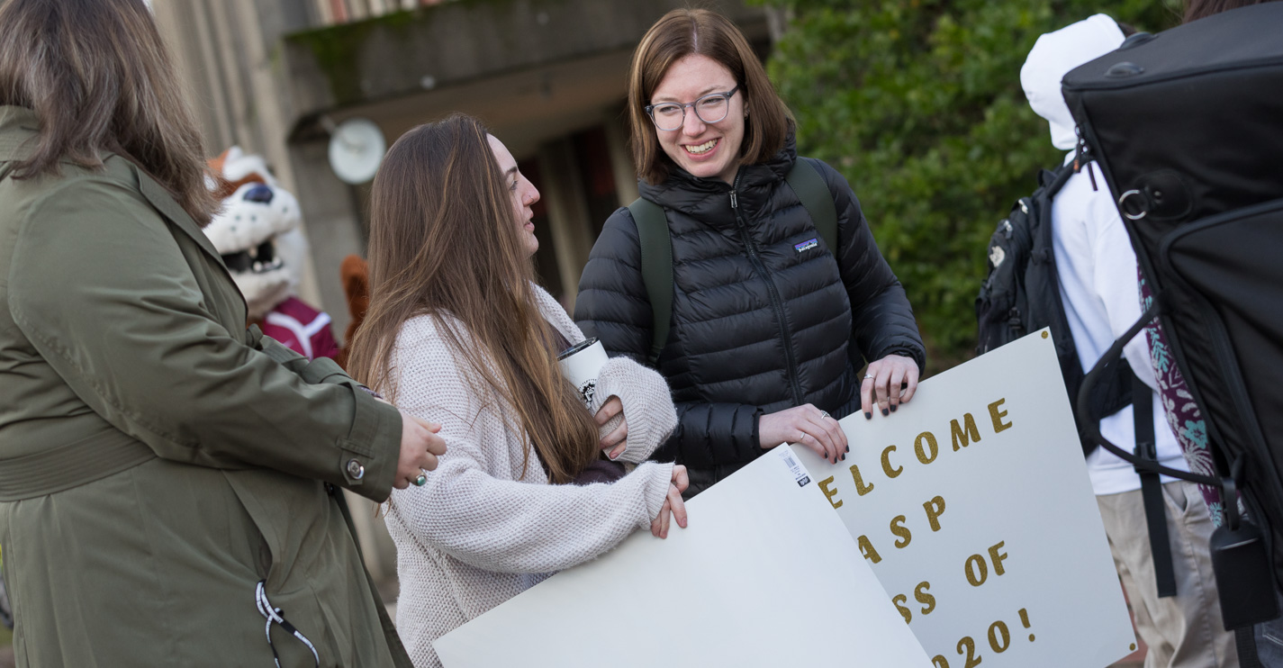 Two students with a sign that says Welcome ASP Class of 2020!