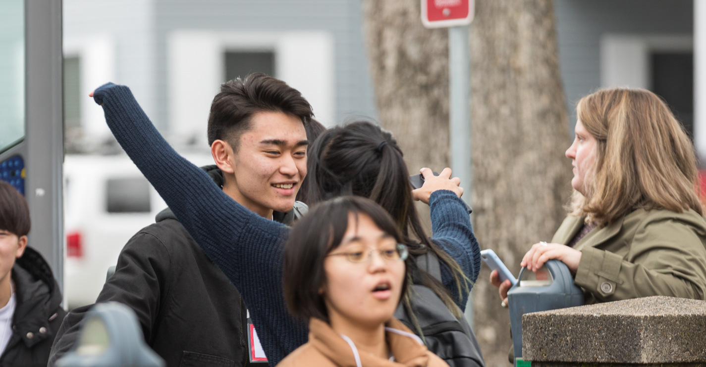 Two students greet one another with a hug