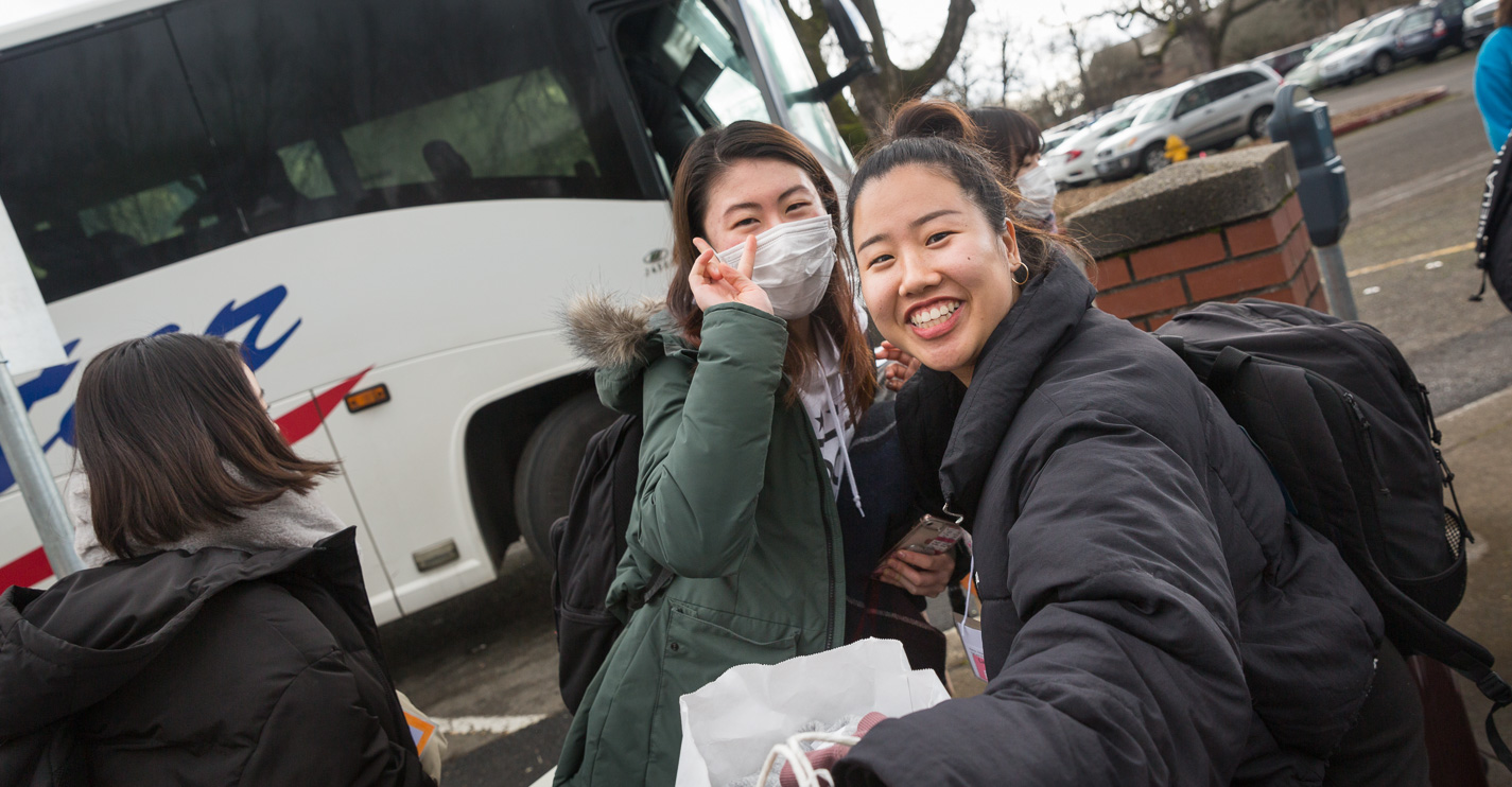 Two ASP students smile as the crowd greets them with cheers