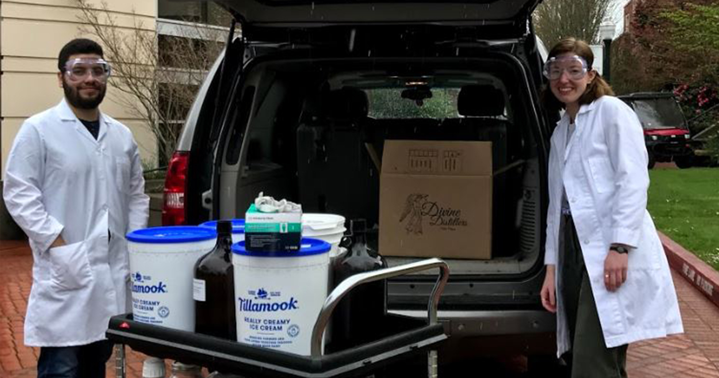 Students in PPE load ingredients into a van