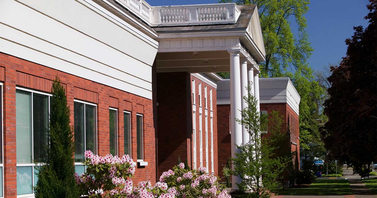 Willamette Law building with pink rhododendron in bloom