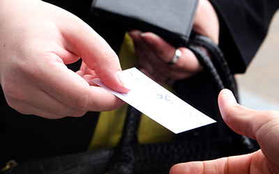 Hand passing business card 