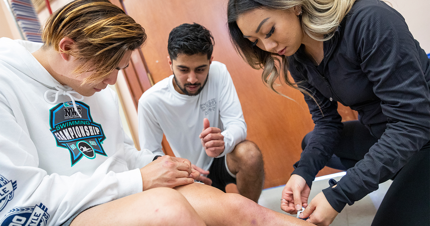 Katie Lee applies works on the leg of a student