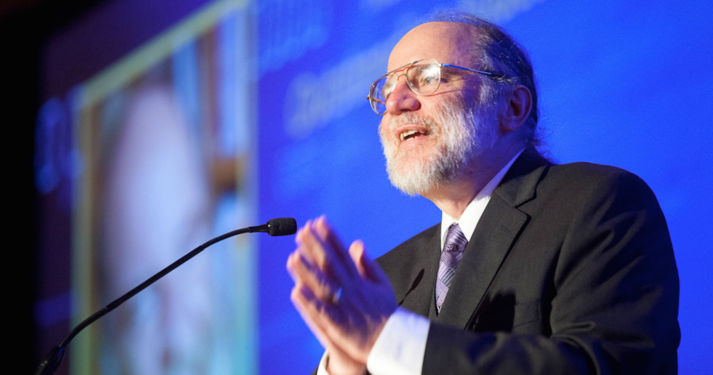 Professor Emeritus Eric S. Roberts speaks at podium