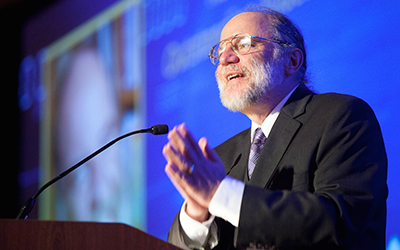 Professor Emeritus Eric S. Roberts speaks at podium