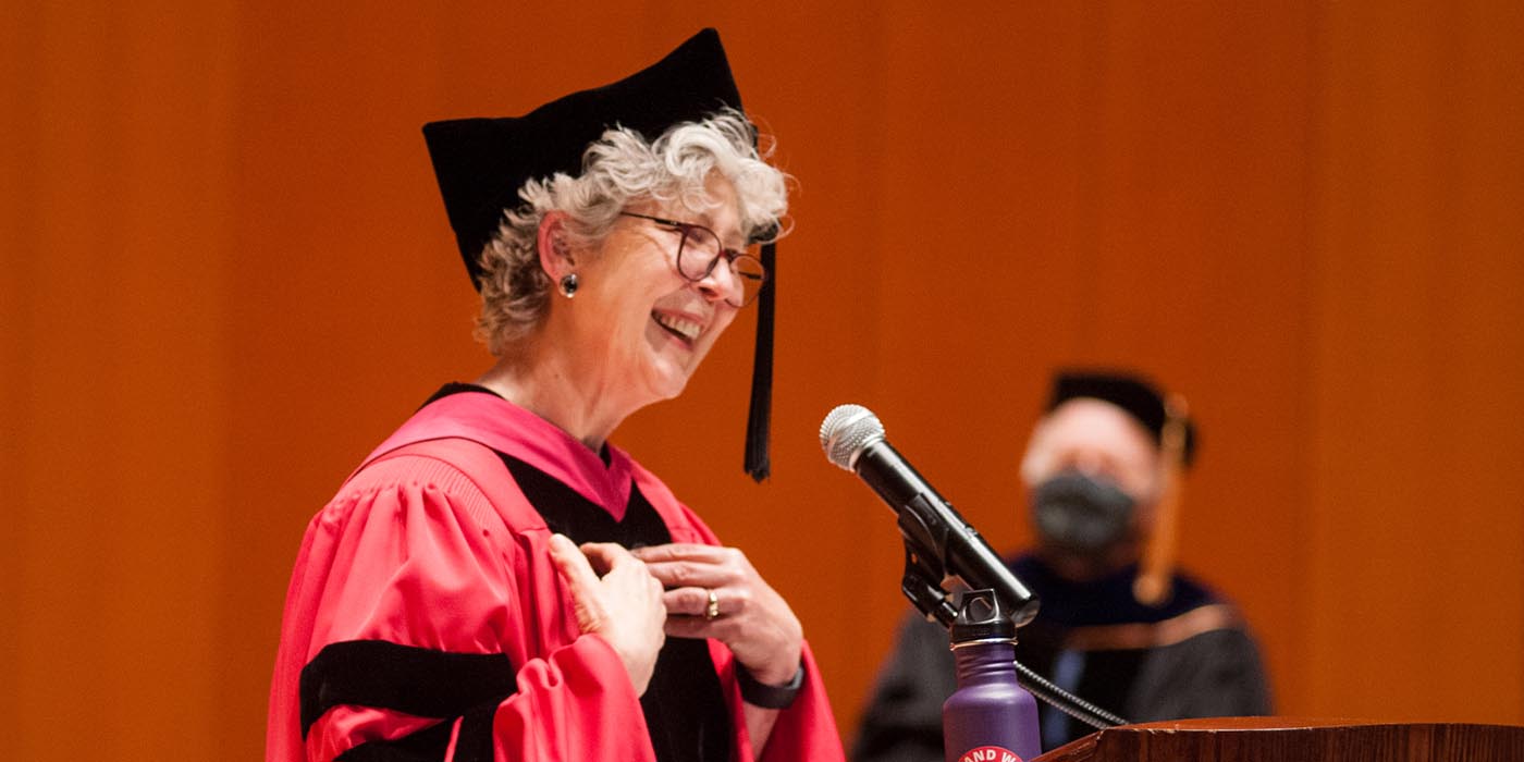 Chaplain Karen Wood speaks at a podium