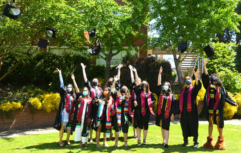 Sociology graduates toss their caps into the air