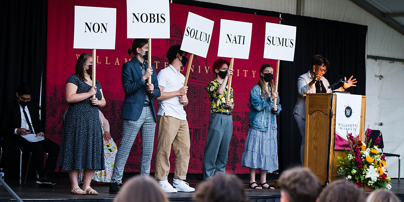 Chaplain Rev. Ineda Adesanya and student leaders teaching the new students how to say Willamette's motto.