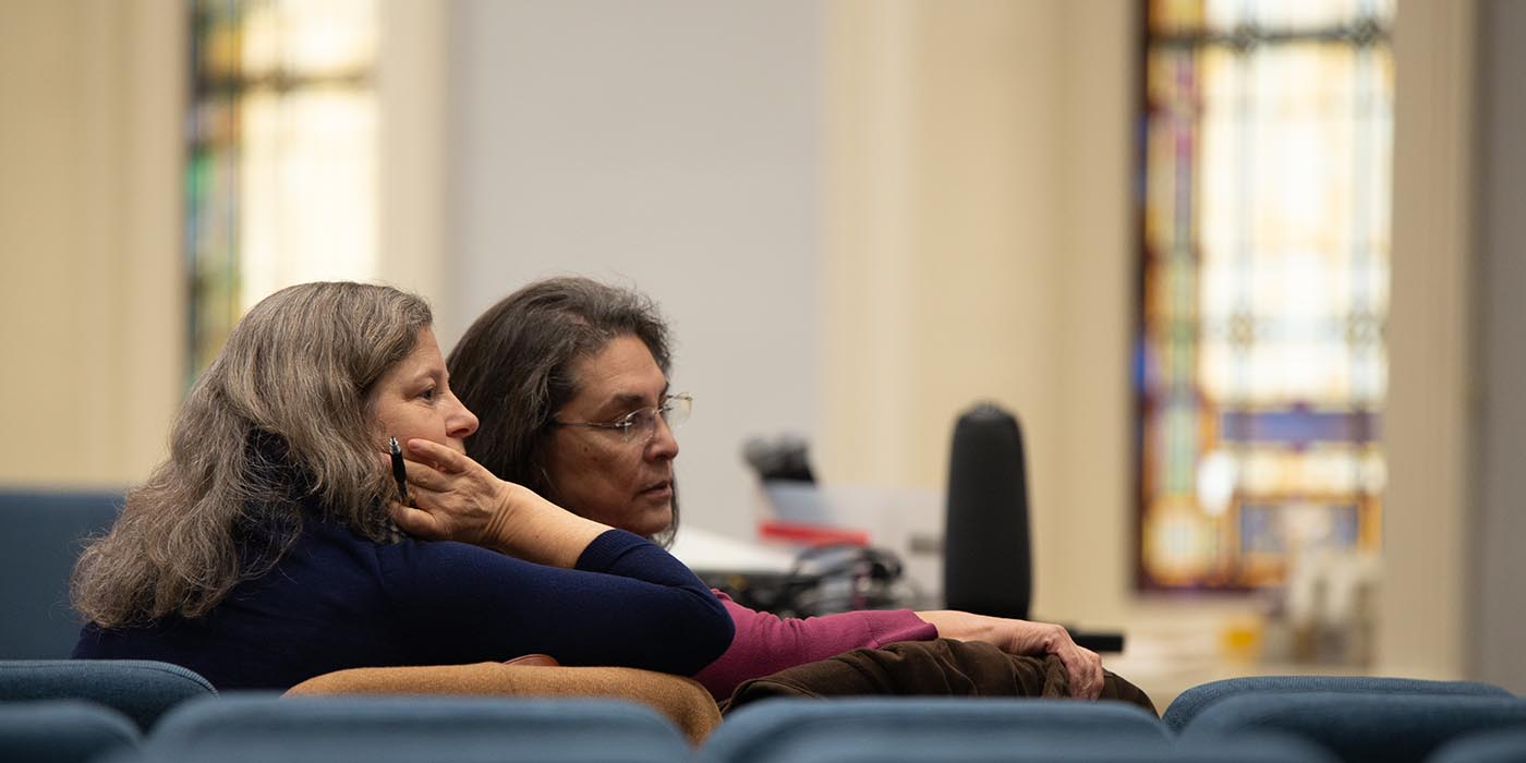 Staff members listening to the talk