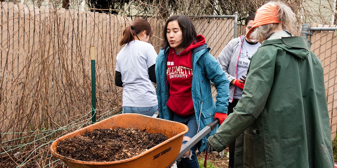 Student pushes a wheelbarrow