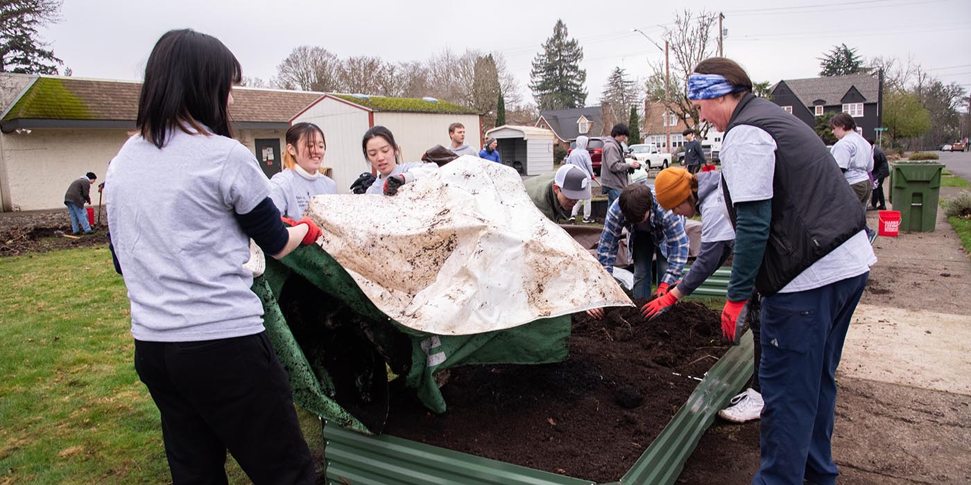 Students stretching out a tarp