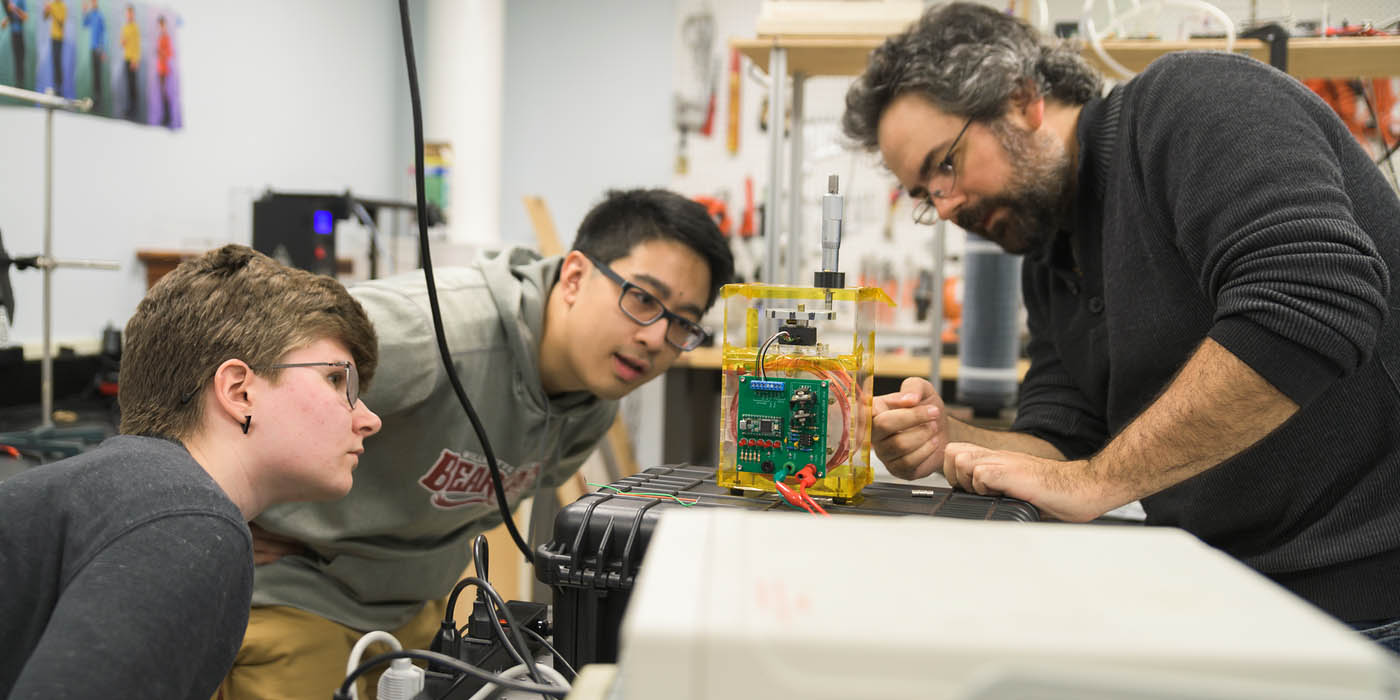 Students conduct experiments in physics lab