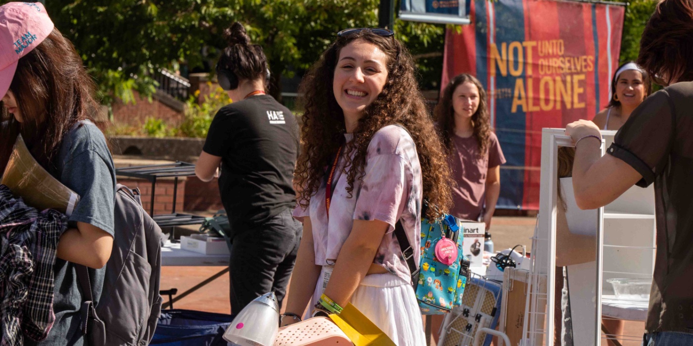 A student participates in the rummage sale.