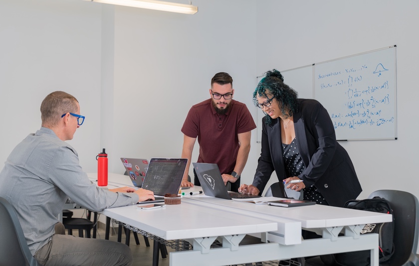 Faculty working together around a table