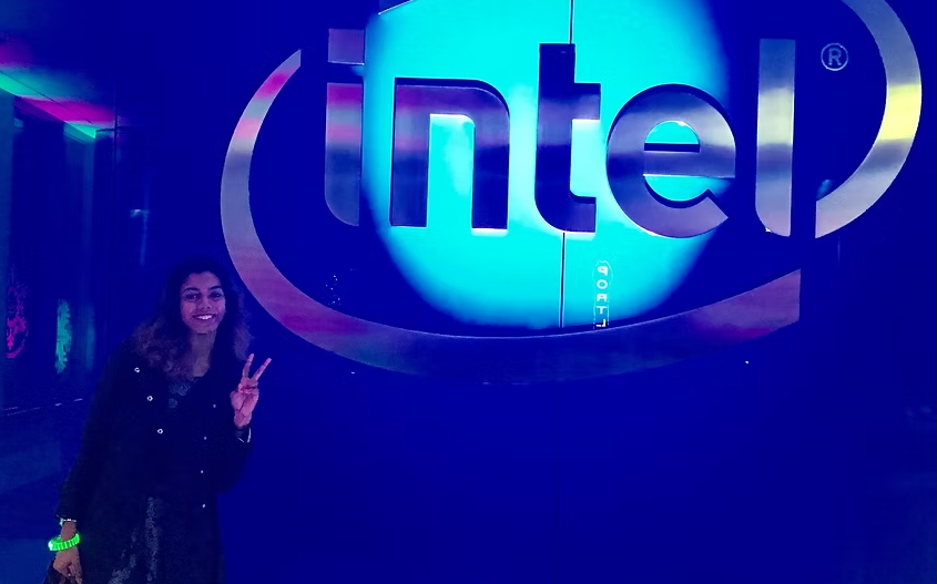 Wilson standing in front of Intel sign