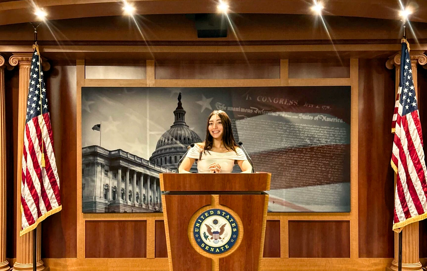 Agustina standing in front of a podium