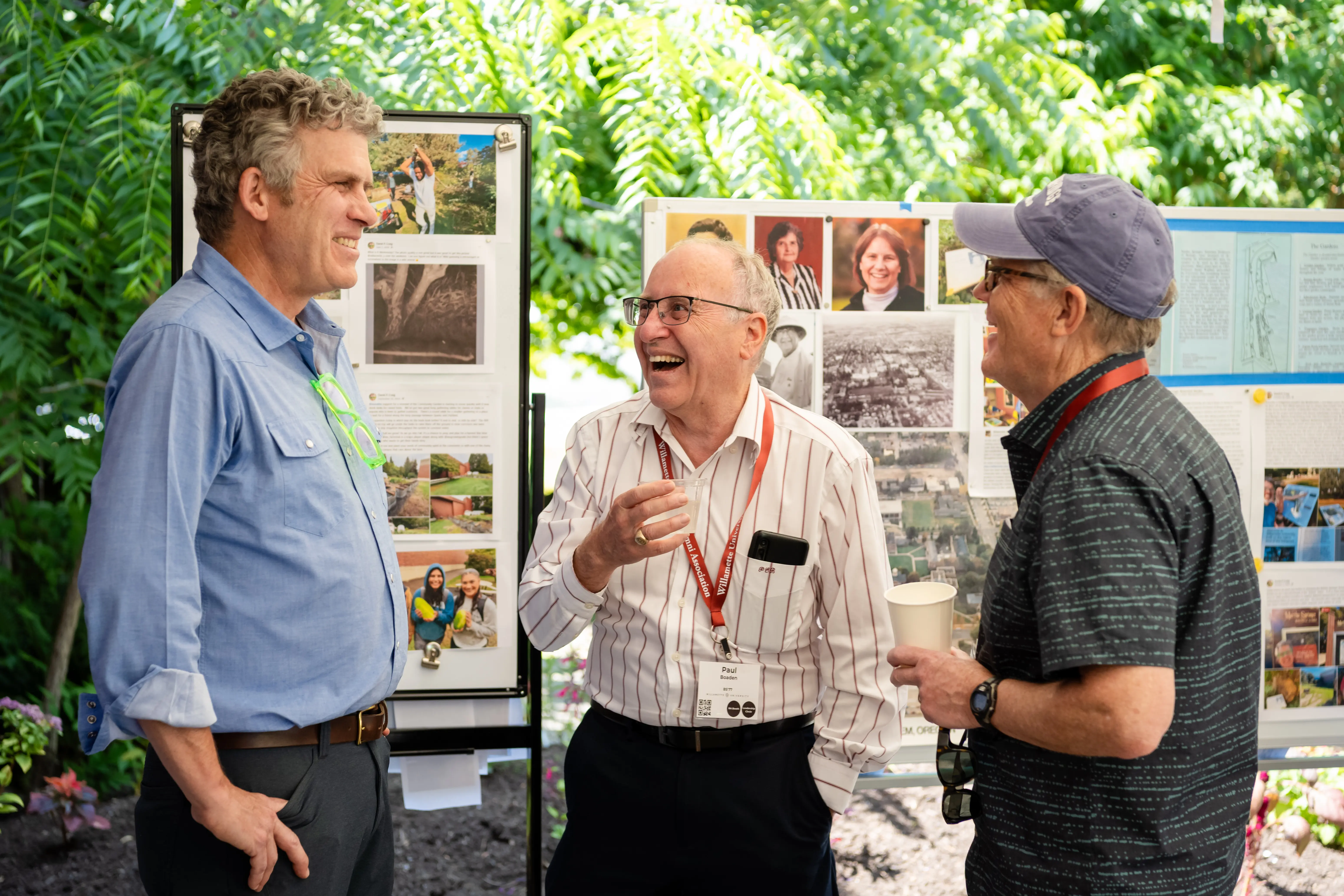 Three men standing in a garden