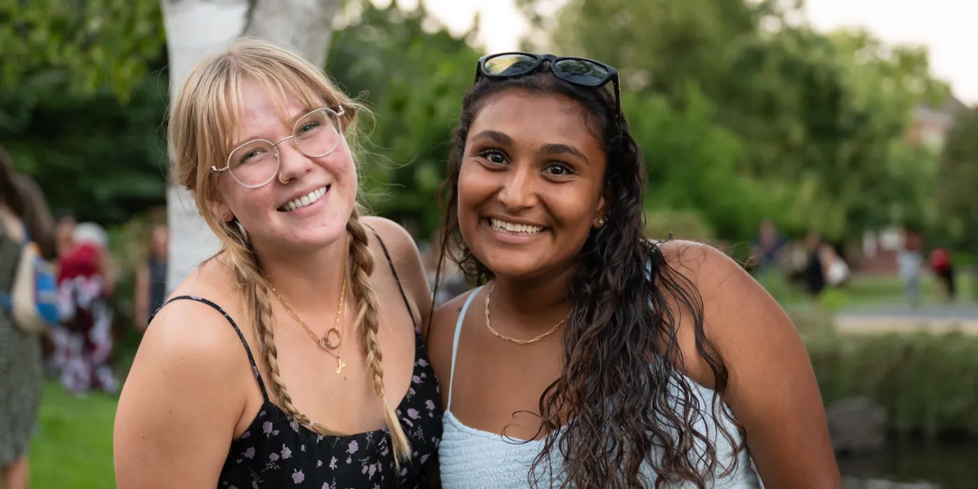 Two students smiling