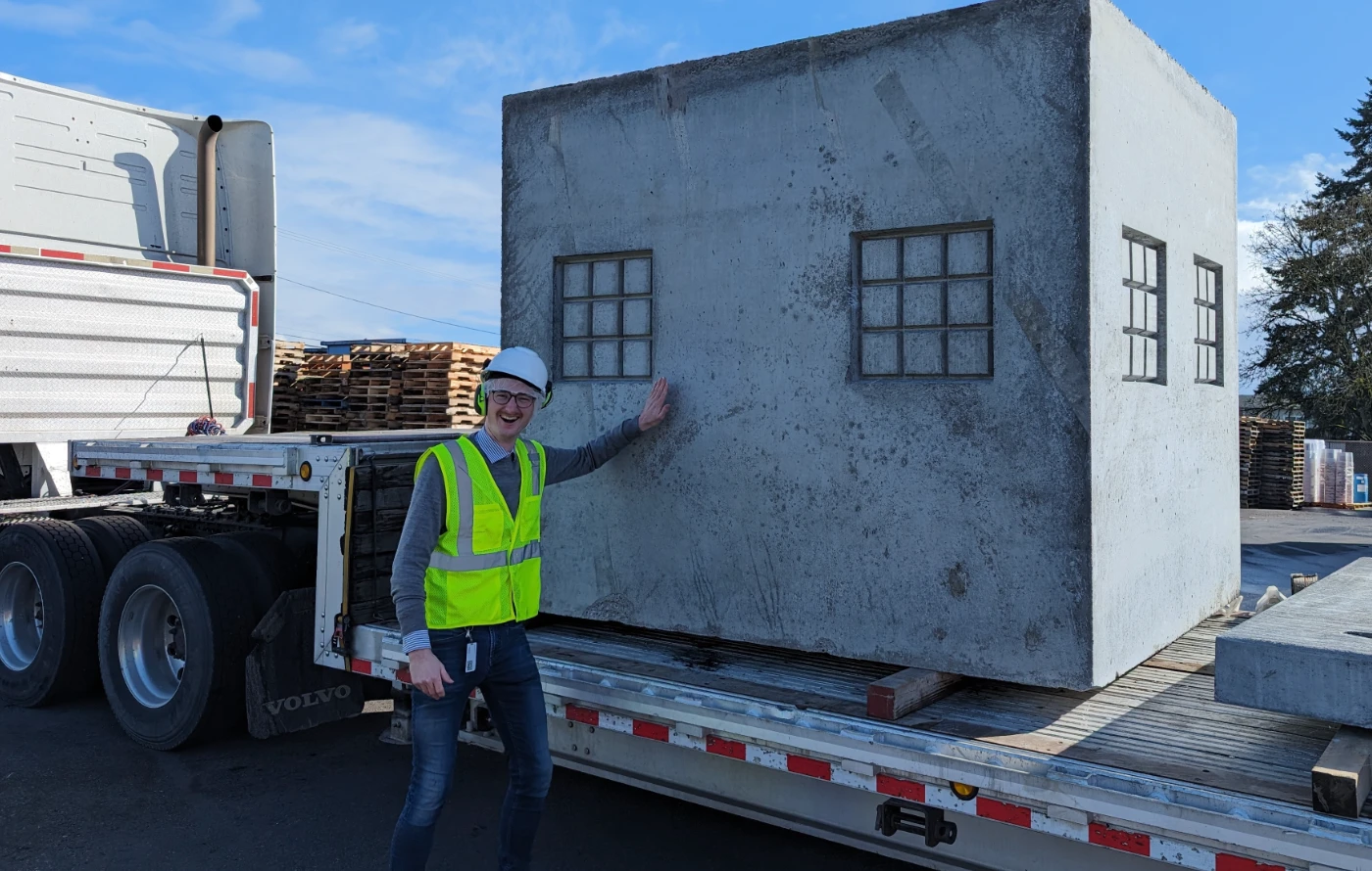 Jadrian posing with a truck and industrial equipment