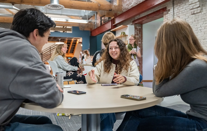 Three people sitting around a table