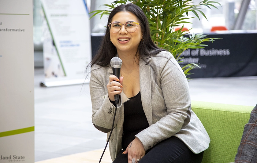 Woman sitting in a chair with a microphone 