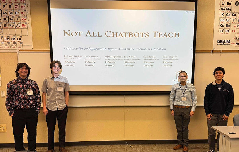 Four people standing in front of a screen