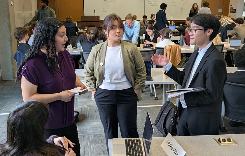 Three people having a discussion 