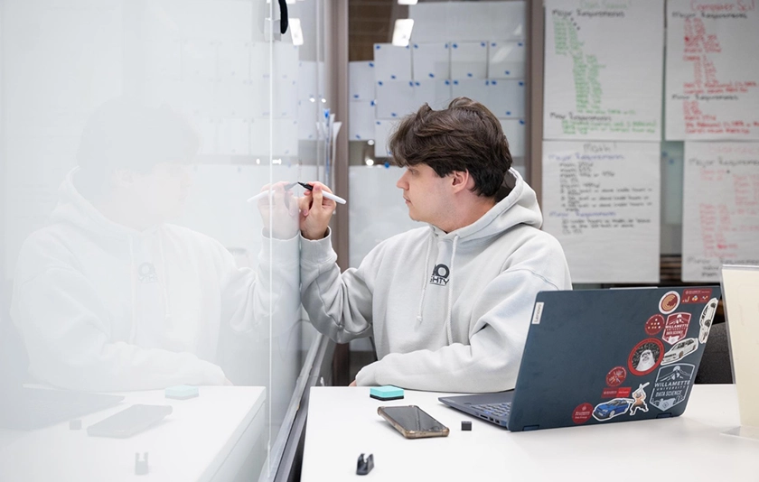 Student writing on a whiteboard