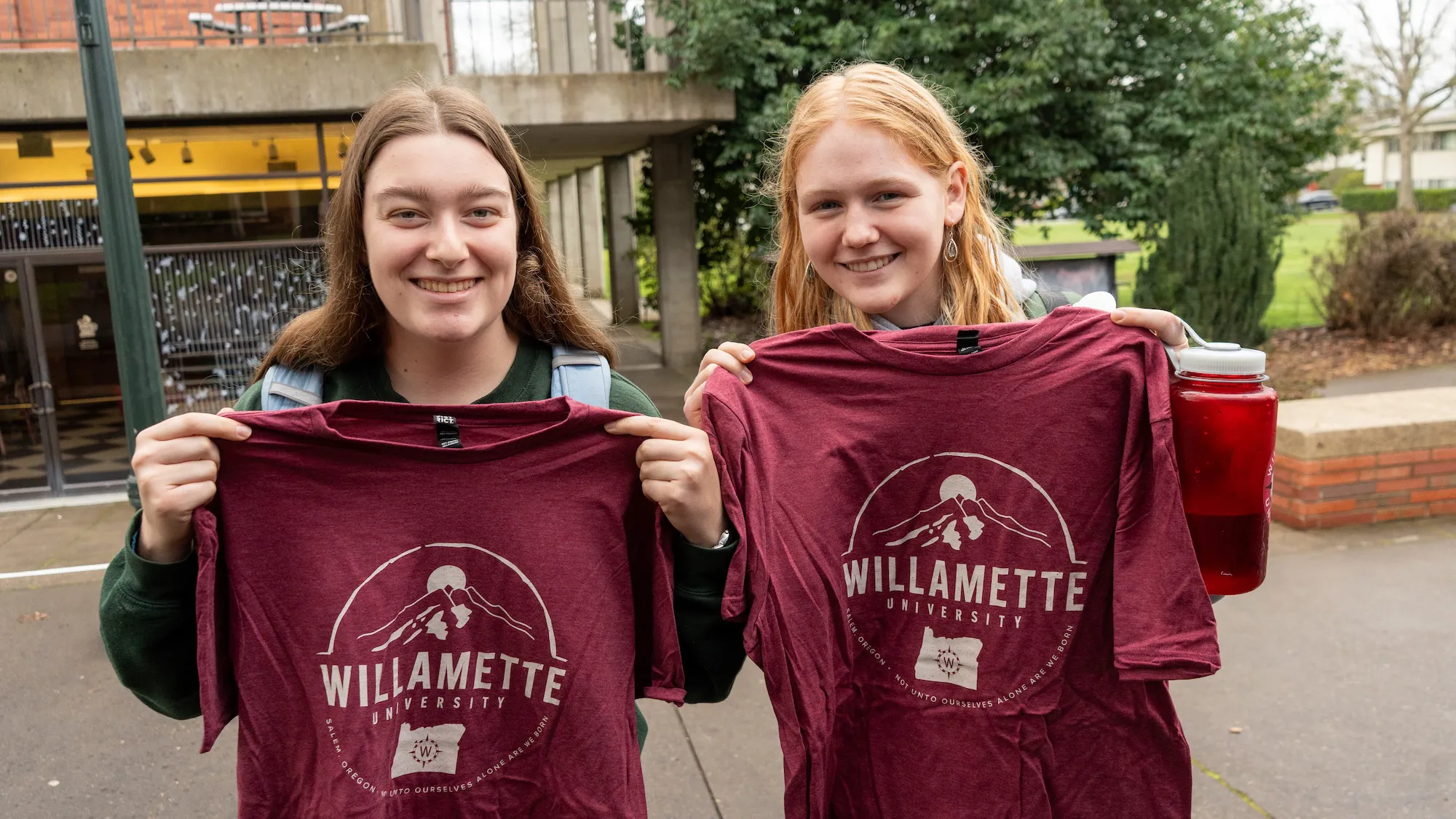 Students holding a Willamette shirt