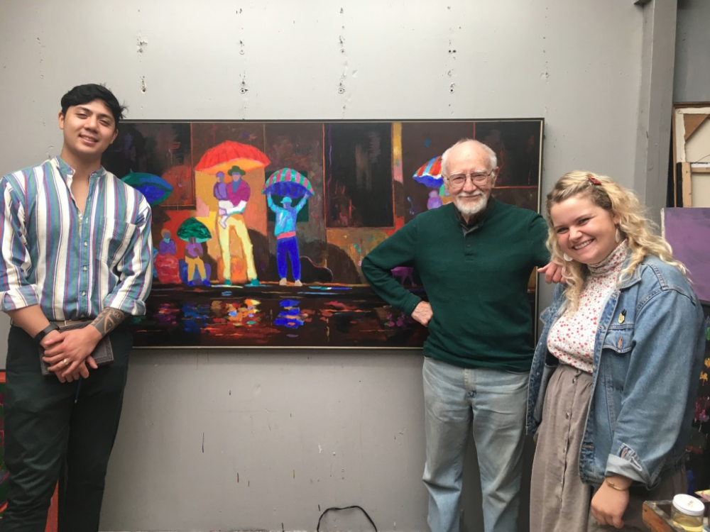 George Johanson, Christopher Camcam, and Olivia Harwood in front of a Johanson painting