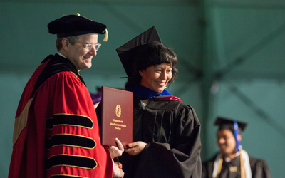 President Thorsett awards a diploma