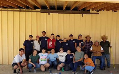 Students on Take a Break in Fresno stand in front of a building they painted.