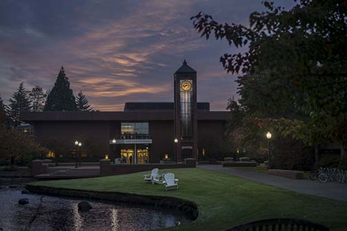 Image of Millstream and Hatfield clocktower with pink sky at dawn