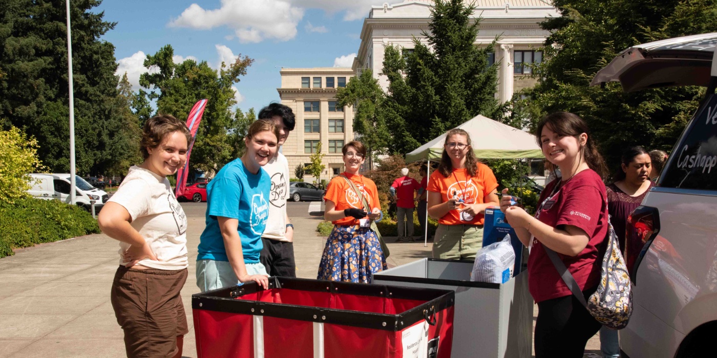 Current students and staff help with new student move in.